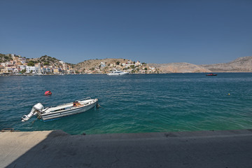 Scenic view of the sea surface of Symi island, Greece. Ships and yachts in the bay of the island on the Aegean Sea. 