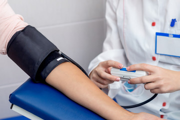 Doctor measures the pressure.