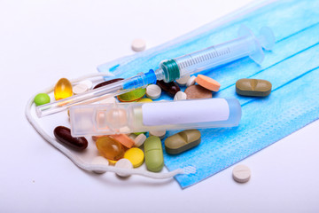 Coronavirus or other virus concept on a paper background with medicines and protective mask. Novel coronavirus 2019-nCoV. Covid-19 surface for text.