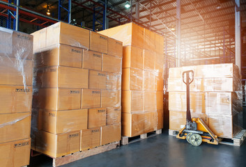 Interior of warehouse, stack package boxes on pallets and hand pallet truck, warehouse industry...
