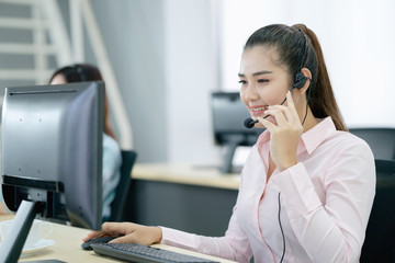 Young female operator with headphone