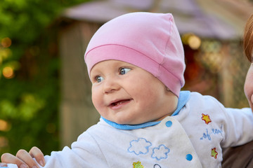 baby first two teeth,the little baby girl laughs with the first teeth opening her mouth