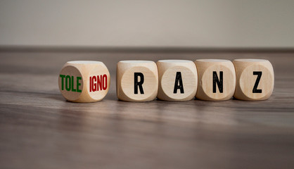 Cubes and dice with german words for tolerance and ignorance - toleranz und ignoranz on wooden...
