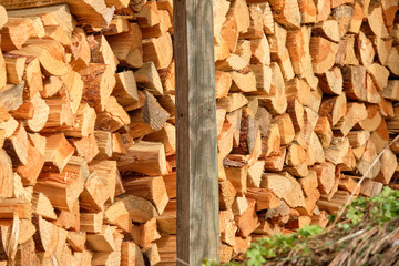 Closeup of a heap of firewood lying piled up in a garden. Seen in Germany in March.