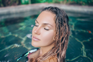 Beauty and body care. Sensual young slim sexy girl relaxing in outdoor spa swimming pool. Skin face...