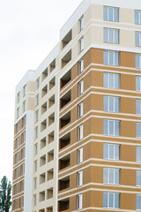 Fototapeta premium Details of new house. New-constructed unfinished multi-storey residential building. multi-storey residential house in brown and beige colors. Modern residential construction. Residential fund