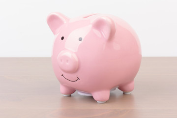 Piggy bank  on wooden background, space for text. Finance, saving money