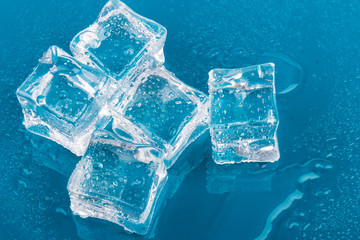 ice cubes and water drops close up on blue background