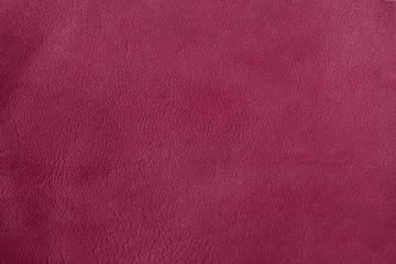 Texture of genuine leather close-up, visible texture, trendy burgundy color, pattern for bright backdrop