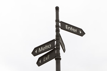 arrow pointer showing directions of entrance and exit from the metro, the road sign is on the street on a white background