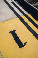 platform 1 marked on the floor of a speed bump at the train station