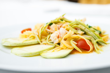 Tagliatelle with tiger prawns served on a plate