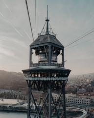 cable car tower through the port of barcelona at sunset
