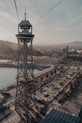 cable car tower through the port of barcelona at sunset