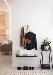 Obraz premium Hallway interior with stylish furniture, clothes and accessories
