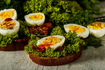 Fresh boiled egg with lettuce, parsley and dill. Healthy nutrition. Morning breakfast. Healthy organic natural food concept. View from above