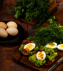 Fresh boiled egg with lettuce, parsley and dill. Healthy nutrition. Morning breakfast. Healthy organic natural food concept. View from above