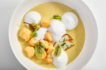 Wild mushroom cream soup with cheese profiteroles