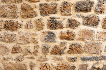 fragment of an old stone wall in the old city. wall in the old city