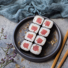 On a gray background rolls with tuna