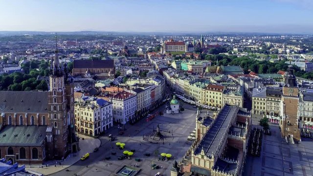 Krakow, Poland. Aerial 4K video of old city, with Main Market Square (Rynek), St. Mary church, old drapers&rsquo; hall, Mickiewicz statue, St. Adalbert small church. Approaching Wawel castle and cathedra