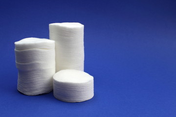 Cotton pads are stacked on a blue background