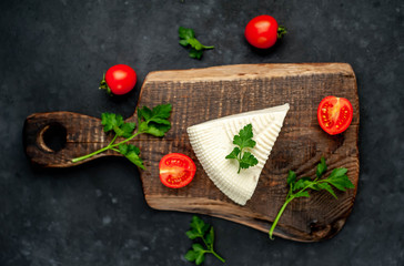 feta cheese on a cutting board on a stone background