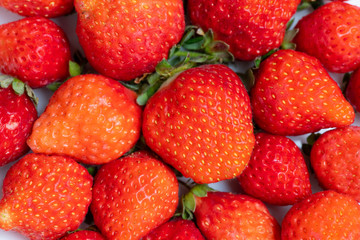 Fresh strawberries in white porcelain plate on wooden table