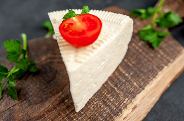 feta cheese on a cutting board on a stone background