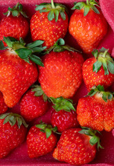 Fresh strawberries in white porcelain plate on wooden table