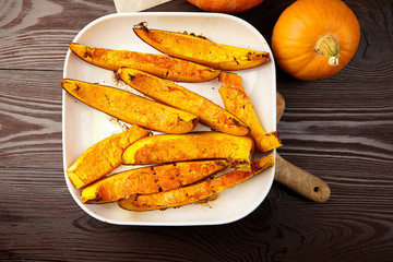 Slices of baked pumpkin in white ceramic bowl