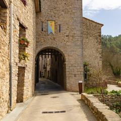 Fototapeta na wymiar View of an access door to the historic center of St Llorenzo of La Muga.