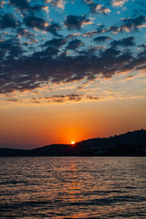 Early morning , dramatic sunrise over sea and mountain.