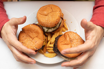 three hamburgers in a plate