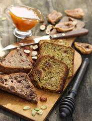 Healthy food. Bread with figs and seeds on a wooden board. Nuts, figs, honey, pumpkin seeds on a wooden background. Rustic. Background image, copy space