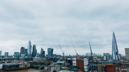 London winter overcast day panoramic skyline with skyscrapers and building cranes. Dull cloudy day