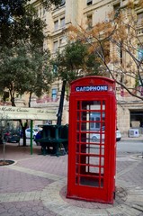 Fototapeta na wymiar Vintage British Red telephone box in the old town of Saint Julian, Malta 