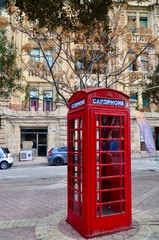 Fototapeta na wymiar Vintage British Red telephone box in the old town of Saint Julian, Malta 