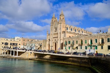 Fototapeta premium Church of Our Lady of Mount Carmel, evening time, located at Balluta bay between Sliema and Saint Julian's (San Giljan) towns