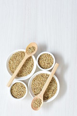 Seed of birdseed, food for birds, displayed in containers on white wooden background