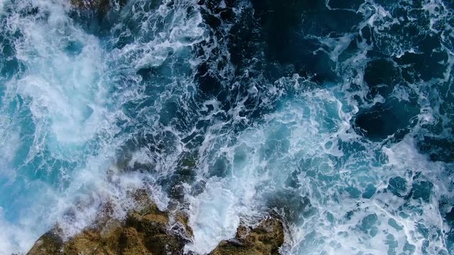 Wild Ocean water from above - Waves hitting the rocks - aerial photography