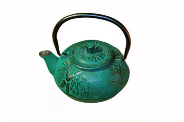 Close-up of a cast-iron tea pot for brewing green tea isolate on a white background.