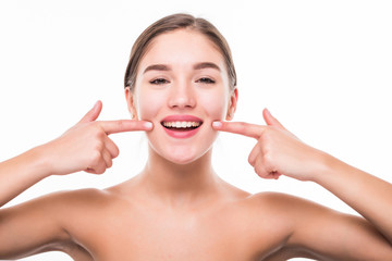 Young woman showing her perfect straight white teeth isolated on white background