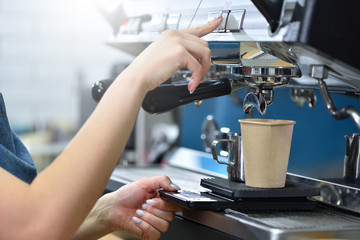 Barista makes coffee on a coffee machine. Hands close-up