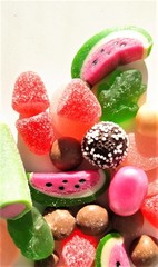 Very bright texture, background with colorful sweet and tasty marmalades and sweets of different shapes with place for text.
