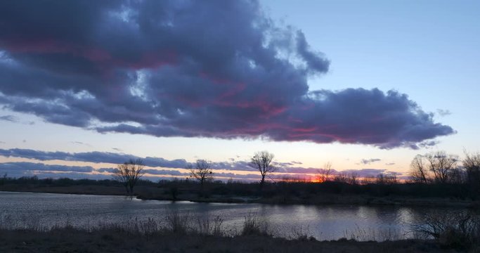 EC4 Evening Colorful  Cloudscape and Sunset above Field, Plains, Grove and River. Wind Blowing Dramatic Clouds. Rural Countryside Landscape. Season change Autumn, Winter, Spring