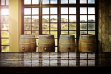 Naklejka premium Desk of free space and blurred interior with barrels 