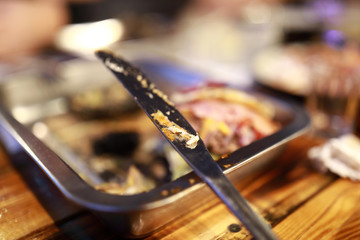 Knife with leftover food on plate