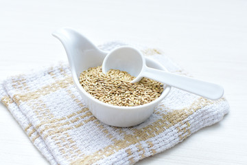 birdseed seeds, food for birds, displayed in containers on cloth bottom