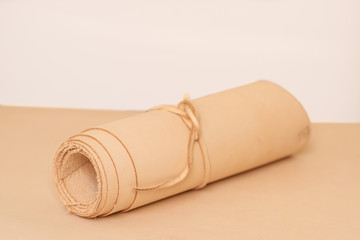 A roll of vegetable tanned raw leather on rolled up on white background